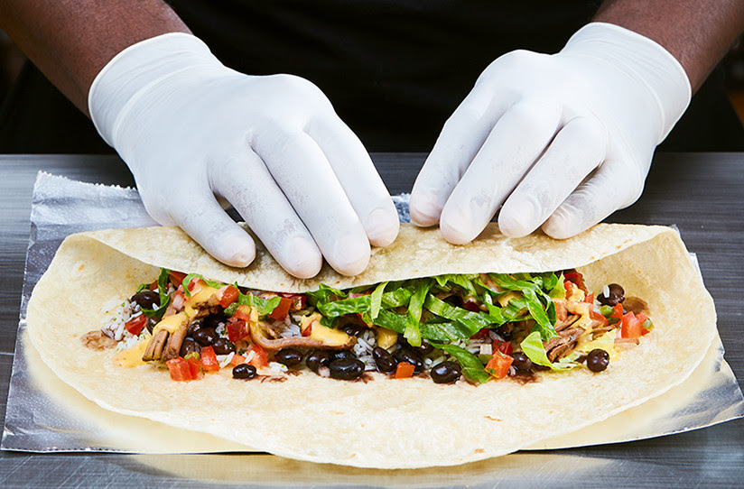 Photo of a burrito being wrapped.